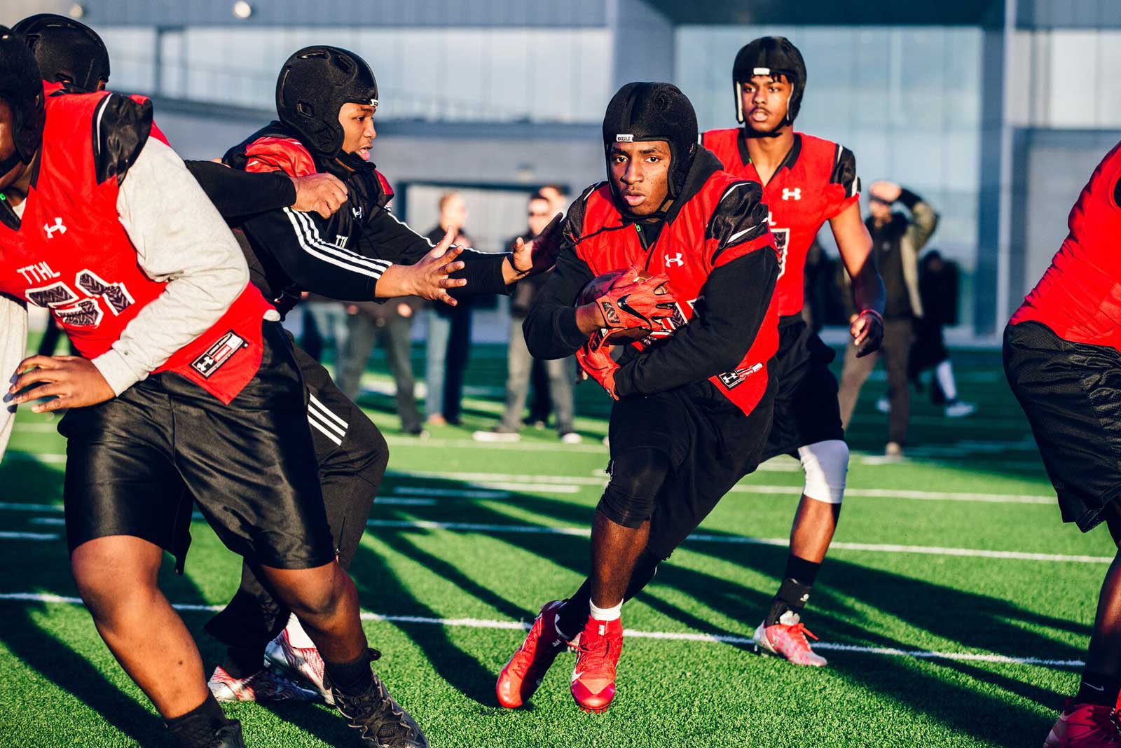 Football players wearing Rocksolid headgear during a play